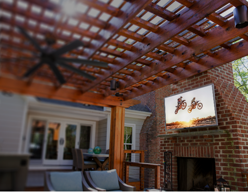 Sunbrite television installed over an outdoor fireplace