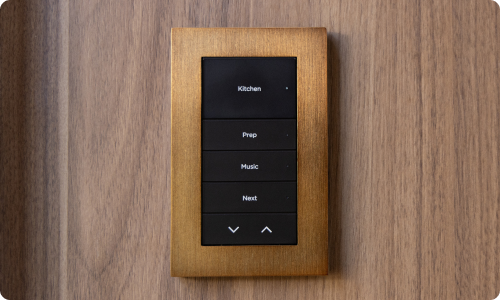 Gold Lux faceplate on wall with engraved buttons