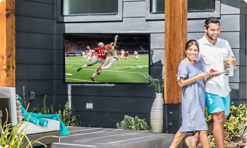 Sunbrite television installed in wall beside a pool