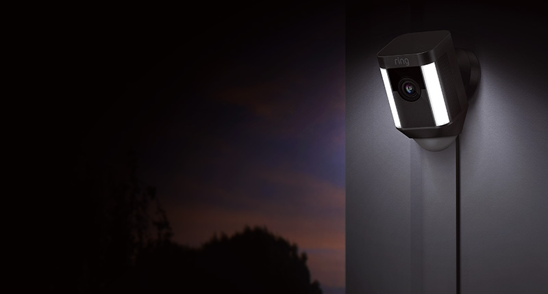 Ring spotlight cam lighting a dark corner of house