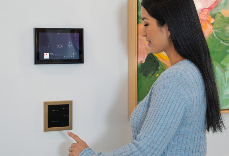 Woman reaching for the Lux lighting keypad