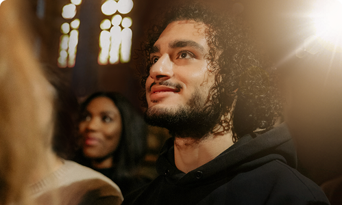 Man with a group of people in a place of worship