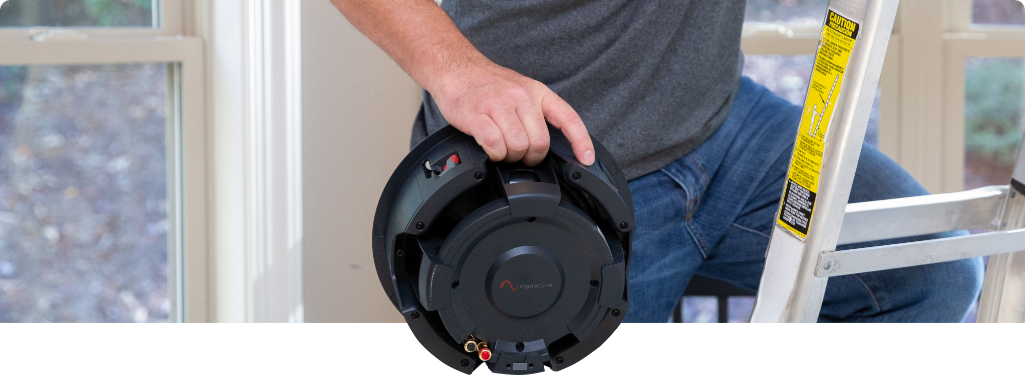 Installer holding a speaker