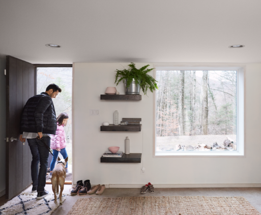 Man, child and dog exiting a house