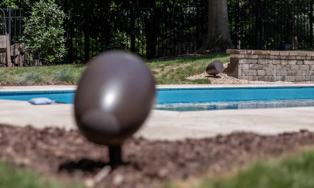Landscape speaker installed among shrubs