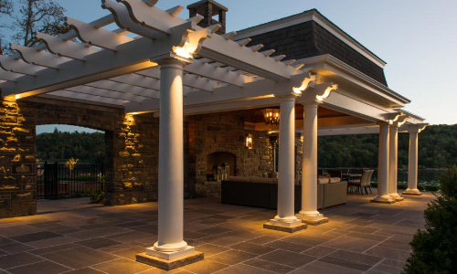 Outdoor patio at night lit up with pergola