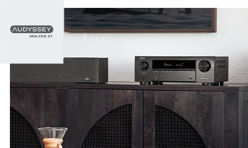 AVR positioned on top of dark entertainment stand