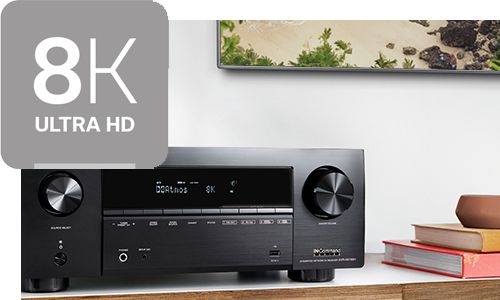 Receiver on top of entertainment stand with 8K icon in top left corner