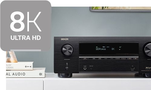 Receiver on top of entertainment stand with 8K icon in top left corner