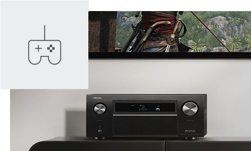 AVR on entertainment stand below TV with game controller icon in top left corner
