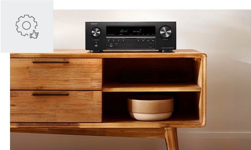 Denon AVR sitting on a entertainment console