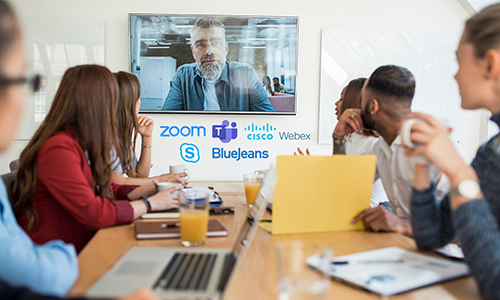 Team in a conference room listening to a Zoom call