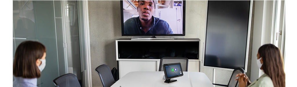 Two people in a meeting room having a video conference