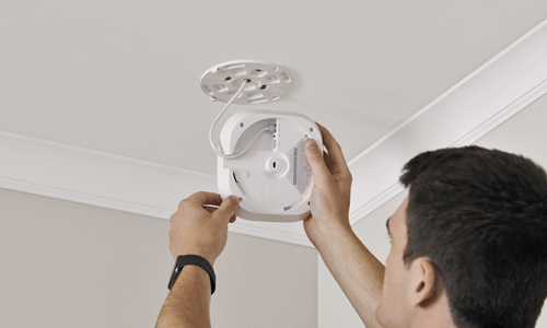 Person installing access point on ceiling