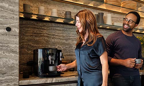 Lifestyle image of a Man and woman making coffee in their home