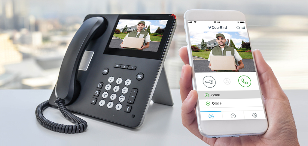 Office phone and smartphone beside each other both displaying a delivery man holding a package