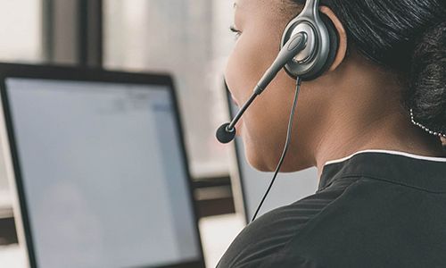 Woman with headset taking support call