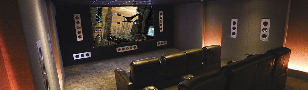 Home theater room with subwoofers installed throughout the room