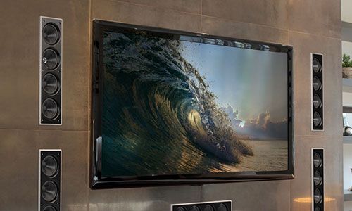 Flat screen with wave scene mounted on wall with in-wall speakers installed on each side