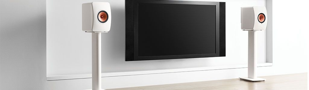 Set of White KEF Performance stands in living room with speakers attached