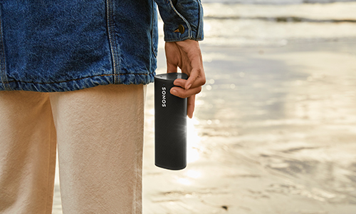 Person holding Sonos Roam next to them