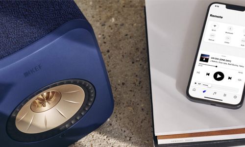 Blue KEF LSX speaker next to mobile device