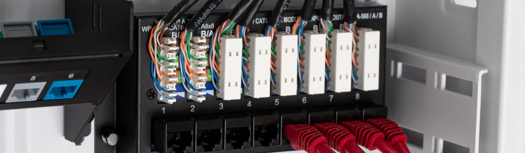 Close up of CAT6A being inserted into punchdowns