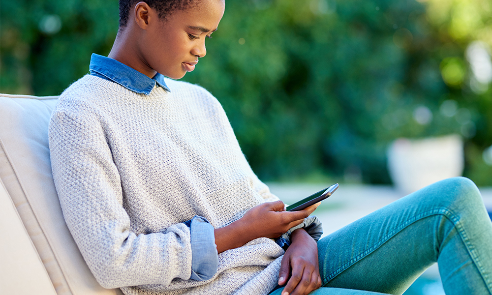 Woman on chair on mobile device