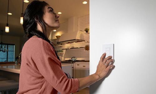 Woman pressing buttons on dimmer